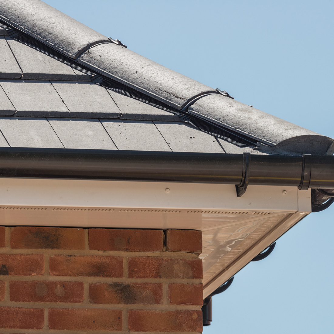 White uPVC fascias, soffits, and black guttering installation London
